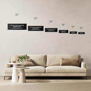 Op de afbeelding: Zwarte rechthoekige wandkunst met de tekst "LET ALL THAT YOU DO BE DONE IN LOVE - 1 CORINTHIANS 16:14 -" in het wit. Beschikbaar in maten van 91 cm tot 30 cm. Geschikt voor woonkamerdecoratie.