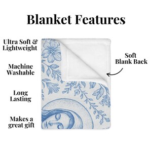 May include: A soft, blue and white fleece blanket with a floral pattern and a drawing of a woman's face. The reverse of the blanket is white. The blanket is machine washable and long lasting. It makes a great gift.