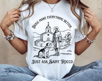 May include: White t-shirt with a black and white illustration of a saint walking a dog. The text on the shirt reads "Dogs make everything better. Just ask Saint Rocco."