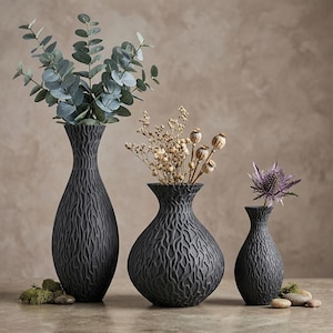 May include: A white ceramic mug with a black handle and the text "But First, Coffee" in a black, bold font. The mug is on a white surface.