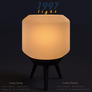 May include: A modern lamp with a ribbed, off-white shade and a black tripod base. The lamp has the text "1997 light" at the top. The lamp body is 140mm x 120mm. The lamp stand is 110mm x 80mm.