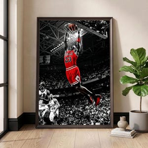 May include: Framed black and white print of a basketball player in a red jersey, number 23, dunking the ball. The background shows a stadium filled with spectators, in black and white.