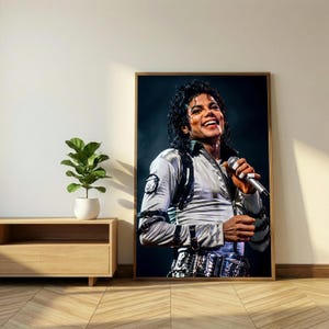 May include: A framed portrait of Michael Jackson, smiling and holding a microphone. He wears a silver jacket with black accents and a decorative belt. The portrait is displayed on a wall next to a wooden cabinet and a potted plant.