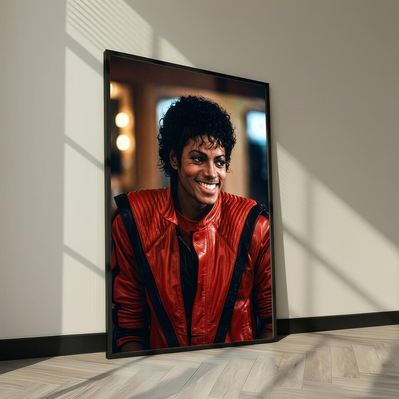 May include: Framed portrait of a smiling person in a red leather jacket with black accents. The portrait is in a black frame and leans against a white wall, with sunlight creating shadows on the floor.