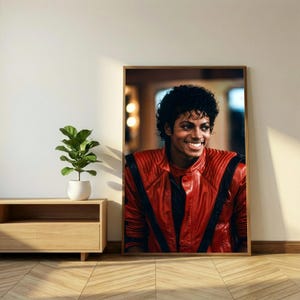 May include: A framed portrait of a smiling person wearing a red leather jacket with black accents. The portrait is displayed on a wall next to a small potted plant and a wooden cabinet.