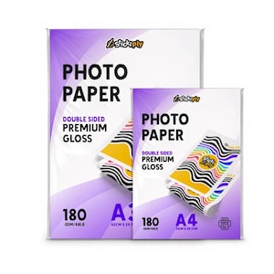 May include: Two packs of StickiPly double-sided premium gloss photo paper. The larger pack is A3 size, 42cm by 29.7cm, and the smaller is A4 size, 21cm by 29.7cm. Both are 180 GSM/48LB and feature purple and white branding with colourful graphic prints.