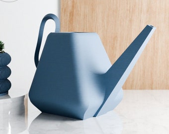 May include: A blue plastic watering can with a long spout. The watering can is sitting on a white marble surface.