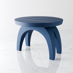 May include: A blue wooden stool with a round top and three curved legs. The top has a striped design.