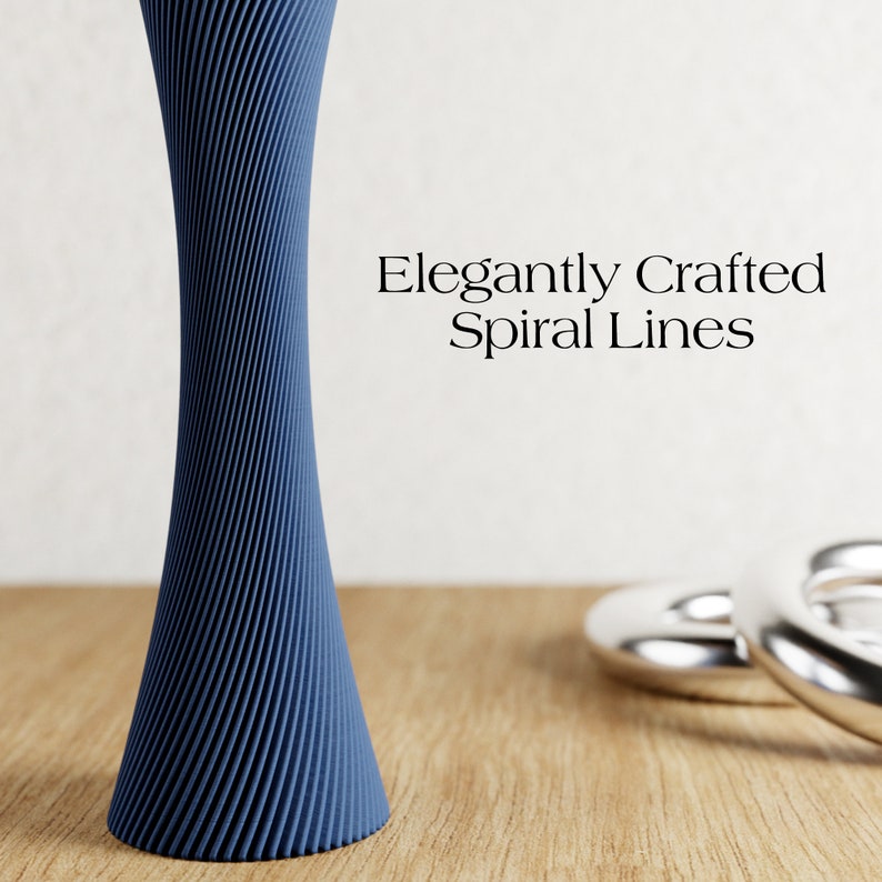 May include: A dark blue vase with a spiral design. The vase is made of a smooth, textured material. The text "Elegantly Crafted Spiral Lines" is written in black text on a white background.