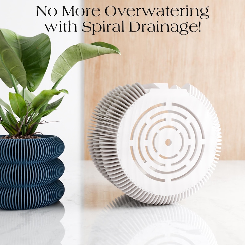 May include: A dark blue, layered planter with a plant and a white spiral drainage system. The planter has a unique design with horizontal lines. The text at the top says, "No More Overwatering with Spiral Drainage!"