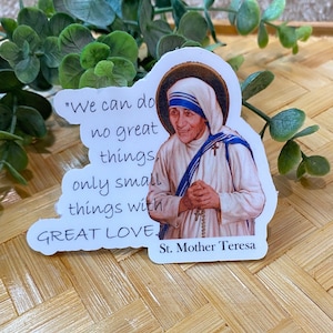 Puede incluir: Pegatina blanca con una cita de la Madre Teresa: "No podemos hacer grandes cosas, solo peque&ntilde;as cosas con GRAN AMOR." La pegatina presenta una imagen a color de la Madre Teresa.