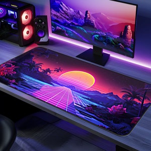 May include: A large, colorful mousepad with a retro-futuristic design. The mousepad features a sunset over a beach with palm trees and a grid pattern in the foreground. The colors are pink, purple, blue, and yellow.