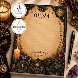 May include: A rectangular notepad featuring a vintage-style Ouija board design with a tan centre, black borders, and illustrations of a moth, sun, moon, stars, candles, crystals, and a planchette. The text reads OUIJA MYSTIFYING ORACLE, GOOD BYE, and WITCHES NOTES.