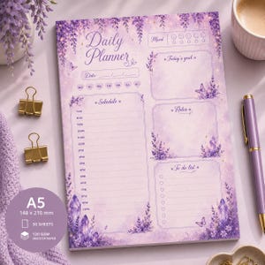 May include: A rectangular daily planner notepad with a lavender floral and crystal theme. The page features sections for mood, today's goal, a schedule from 7 AM to 11 PM, notes, and a to-do list. It is A5 size, 148 x 210 mm, with 50 sheets.