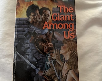 May include: A fantasy novel cover featuring a giant, a sword, and a woman with long hair. The book title is "The Giant Among Us" and the author is Troy Denning. The book is part of the Forgotten Realms series.