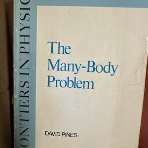 Puede incluir: Un libro antiguo titulado "The Many-Body Problem" de David Pines. El libro forma parte de la serie "Frontiers in Physics". La portada es blanca con texto azul y un encabezado azul claro.