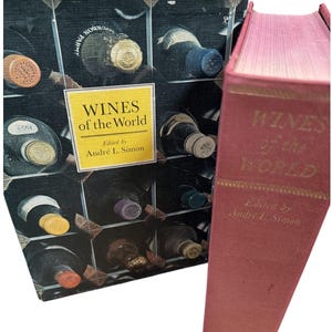May include: Two books titled "Wines of the World" are displayed. One book has a cover featuring wine bottles in a rack, with a yellow label. The other book is red with gold lettering. Both books are edited by André L. Simon.