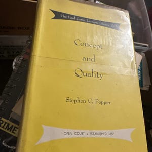 May include: A yellow book titled "Concept and Quality" by Stephen C. Pepper. The book is part of "The Paul Carus Lectures Series 13" and published by Open Court, established in 1887. The book is in a storage box.