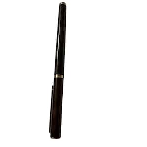 May include: A sleek, dark brown pen with silver accents. The pen has a cap and a clip, and the tip is also silver. The pen is a classic writing instrument.