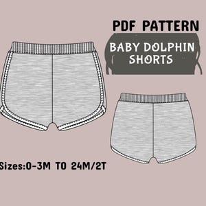Może przedstawiać: Wzór PDF dla spodenek Baby Dolphin pokazano na rysunku liniowym. Spodenki są szare z białym wykończeniem i żebrowanym pasem. Rozmiary wahają się od 0-3 miesięcy do 24 miesięcy/2T.