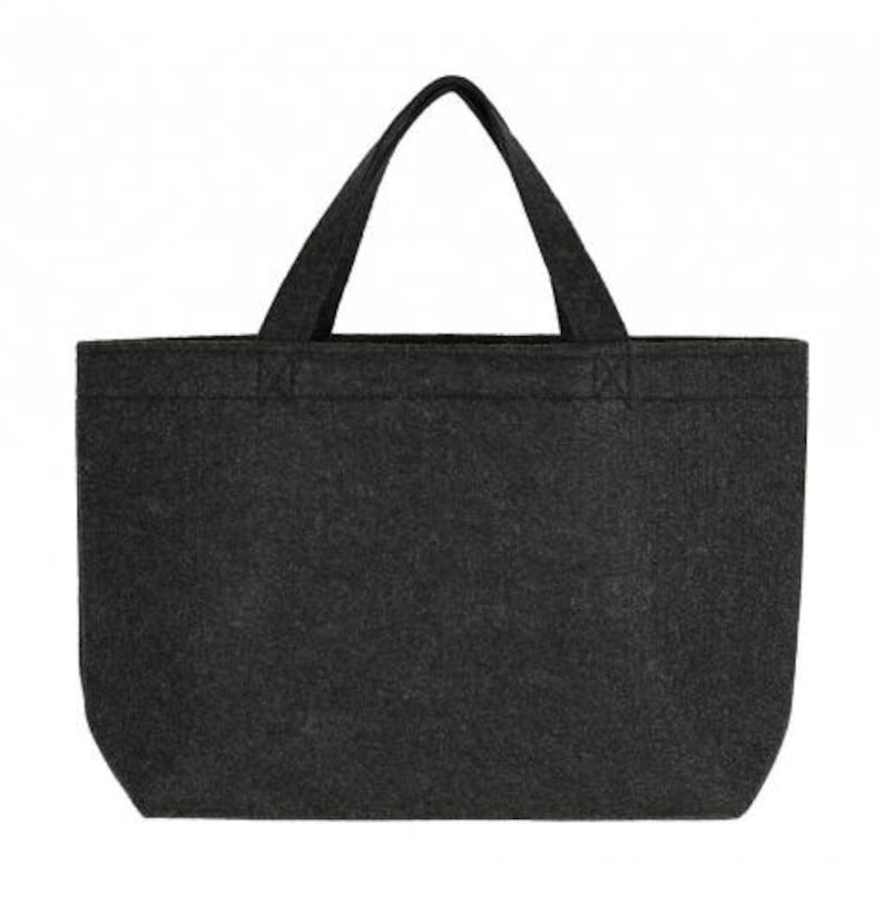 May include: A dark gray tote bag with two sturdy handles. The bag is made of a felt-like material and has a rectangular shape with a flat bottom. The handles are attached to the top of the bag and are the same color as the bag.