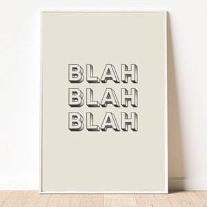 May include: A beige poster with the word "Blah" repeated three times in a 3D style font.