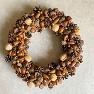 Fall, Christmas, Thanksgiving wreath to hang on the door or put on the table, made from natural oak acorns, pinecones, nuts, cinnamon