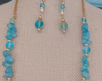 May include: A turquoise and gold necklace and earrings set with a starfish charm. The necklace features turquoise and white beads, and the earrings have a turquoise drop.