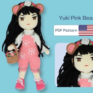 May include: A pink crocheted bear doll with black hair, brown ears, and a flower crown. The doll is wearing a pink overall dress and holding a basket of flowers. The image also includes the text "Yuki Pink Bear" and "PDF Pattern".