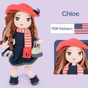May include: A crocheted doll named Chloe wearing a red beret, a blue dress, a striped scarf, and holding a small bag. The doll is standing on a purple background. PDF Pattern.