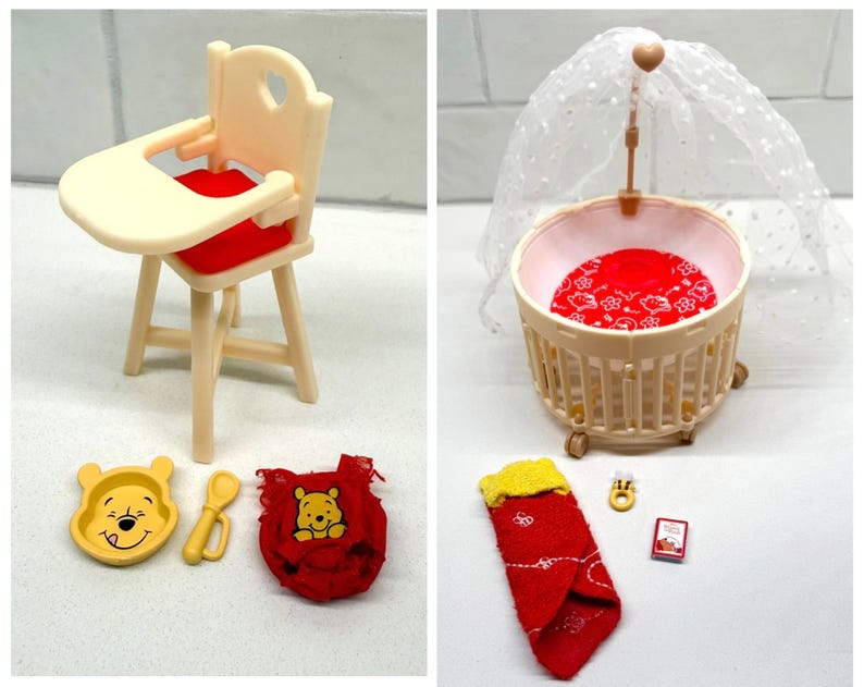 May include: A collection of miniature Winnie the Pooh themed nursery items. Includes a high chair with a red seat, a crib with a canopy, a bowl, spoon, bib, and a sleeping bag. The items are in shades of yellow, red, and cream.