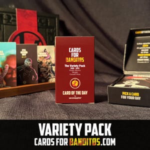 May include: A red "Cards for Banditos" Variety Pack card deck box with text and a logo. The box includes the text "The Variety Pack 2008-2025 Studio Albums Singles Concert Films". The open box shows cards with illustrations.
