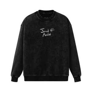 May include: Black sweatshirt with a white embroidered design that says "Jared Micéal" with a small flower graphic.