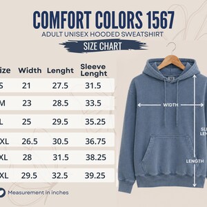 K&ouml;nnte beinhalten: Ein blauer Kapuzenpullover mit K&auml;ngurutasche und passenden Kordelz&uuml;gen, neben einer Gr&ouml;&szlig;entabelle mit der Aufschrift Comfort Colors 1567 Adult Unisex Hooded Sweatshirt. Die Tabelle listet die Ma&szlig;e in Zoll f&uuml;r die Gr&ouml;&szlig;en S bis 3XL auf.