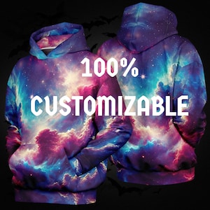 May include: A hooded sweatshirt featuring a vibrant galaxy print with swirling clouds of purple, blue, and pink nebula colors. The front and back views are displayed, with the white text 100% CUSTOMIZABLE printed across the center of the garment.