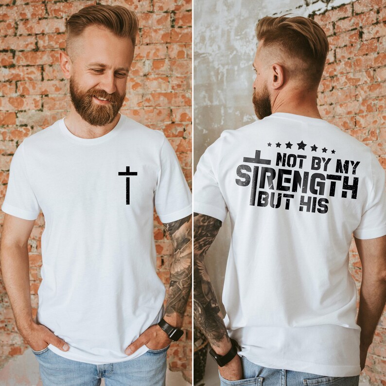 May include: White t-shirt with a black cross on the front and the text "Not by my strength but his" on the back.