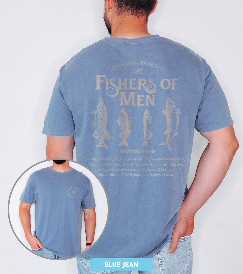 May include: Blue jean short-sleeve t-shirt with the text "JESUS WILL MAKE YOU FISHERS OF MEN" and fish illustrations. The text "MATTHEW 4:18-19" is also printed on the shirt. The shirt has a crew neck and a relaxed fit.
