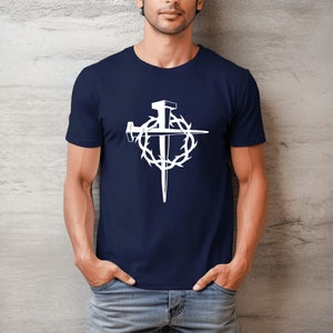 May include: A navy blue t-shirt with a white graphic of a cross with nails and a crown of thorns.