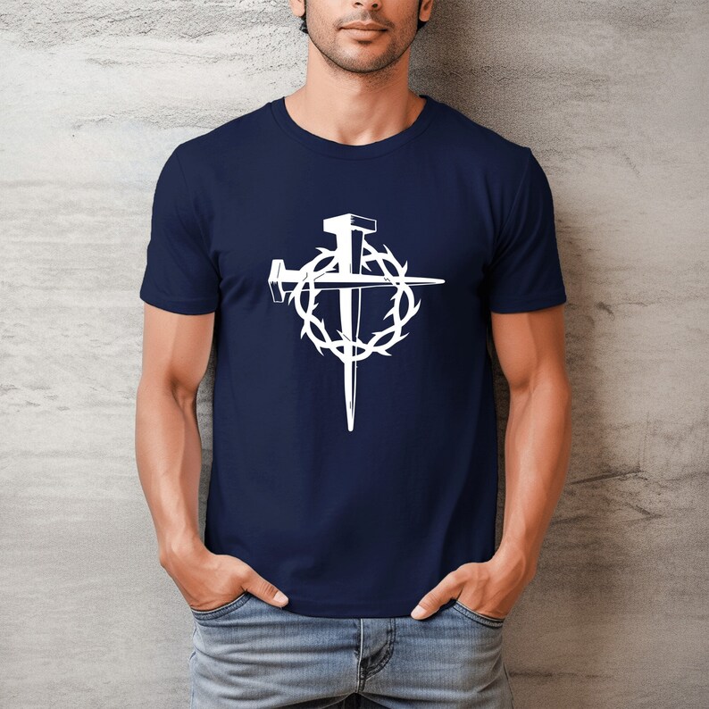 May include: A navy blue t-shirt with a white graphic of a cross with nails and a crown of thorns.
