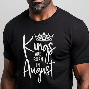May include: Black t-shirt with white text that reads "Kings are born in August" and a crown graphic above the text.