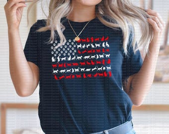 May include: A navy blue t-shirt with a white and red American flag design featuring cats instead of stars and stripes.