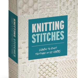 May include: A box set titled "Knitting Stitches" with a teal and white design. The box features various knitted stitch patterns and the text "Learn to Knit Texture in 52 Cards" and the author's name, Claire Crompton.