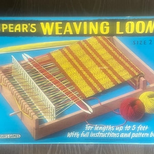 May include: A vintage Spear's Weaving Loom, size 2, with a wooden frame and woven textile. The box is blue with yellow text. Includes yarn in red and yellow. The text reads "For lengths up to 1.5 metres with full instructions and pattern book."