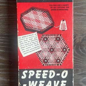 May include: A rectangular red and black box for a Lily Speed-O-Weave set, Art. 717. The box features white text, illustrations of a weaving frame with thread, and a finished hexagonal woven piece. It includes descriptive text about the contents.