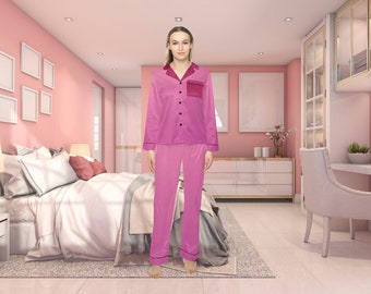May include: A pink satin pajama set with a black trim and a small pocket on the left side of the top. The top has a button-up front and long sleeves.