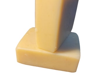 May include: Two bars of pale yellow soap stacked on top of each other.