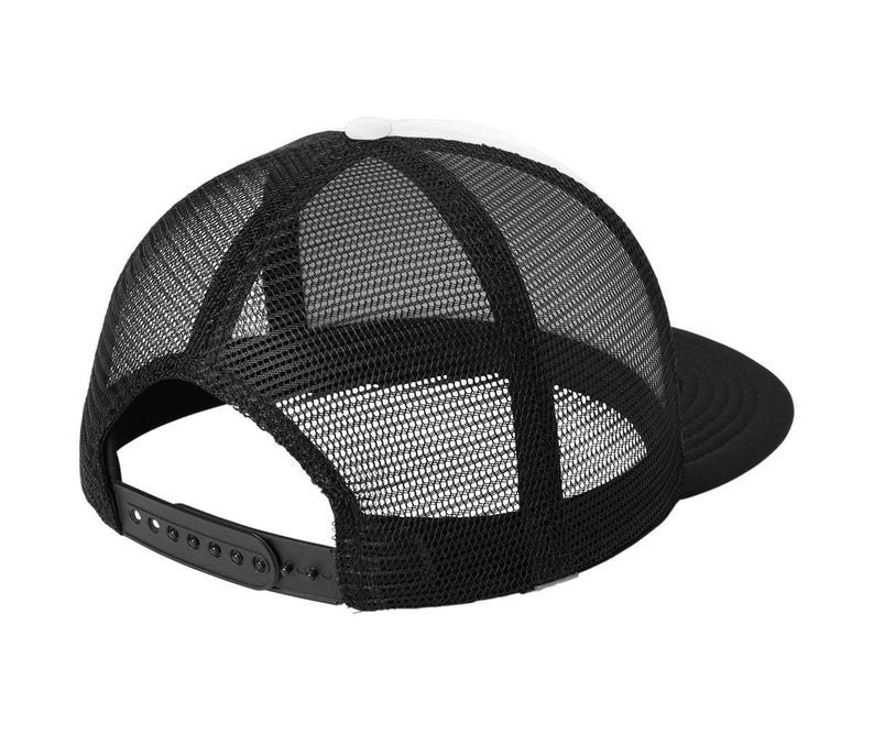 May include: A black and white trucker hat with a mesh back and a curved brim. The hat features a white front panel and a black adjustable snap closure.