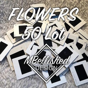 May include: A collection of vintage slide film holders with black frames. The image is overlaid with the text "FLOWERS 50 Lot" and the logo "MBellished DESIGN". The slides are arranged on a white, textured surface.