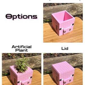 May include: A pink pig-shaped planter with options for a lid and an artificial plant. The planter is made of a blocky, pixelated design, reminiscent of a video game.