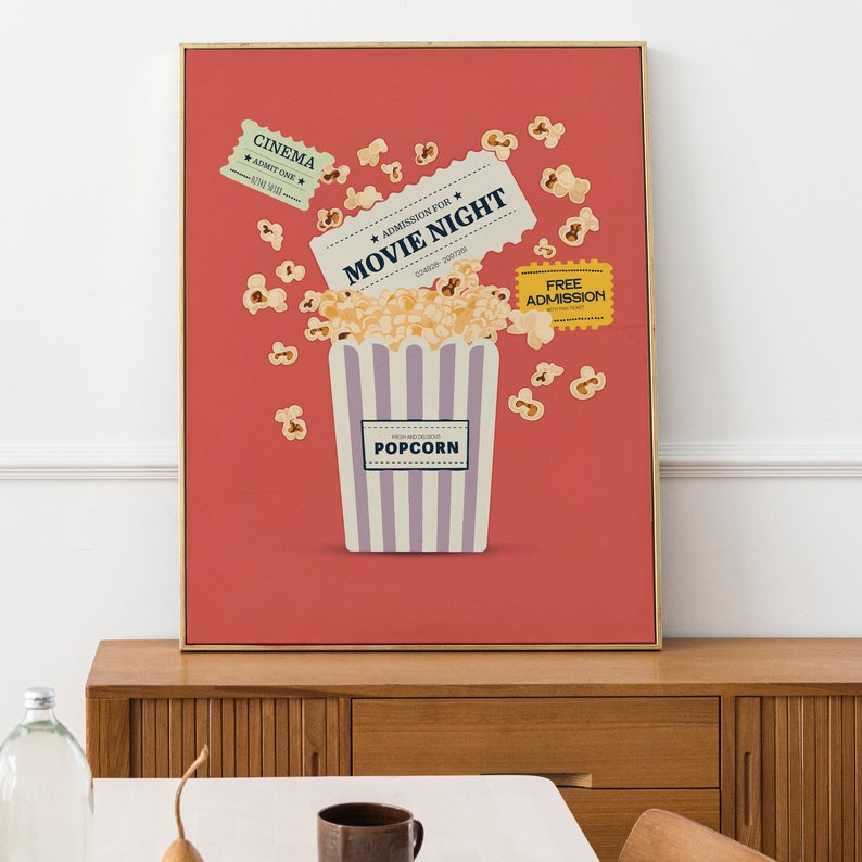 K&ouml;nnte beinhalten: Ein rotes Poster mit einem gestreiften Popcorn-Eimer und Popcorn, das herausf&auml;llt. Das Poster zeigt auch zwei Kinokarten mit der Aufschrift "Eintritt f&uuml;r den Filmabend" und "Kino Zulassen eines".